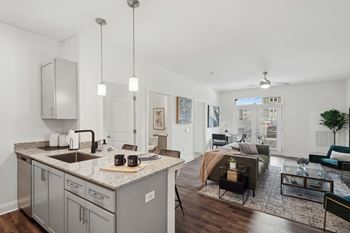 an open living room with a kitchen and a living room